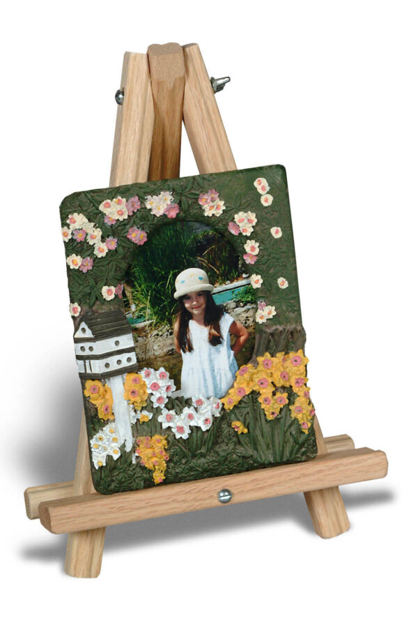 The 12" Display Tripod Easel, holding a decorative photo frame